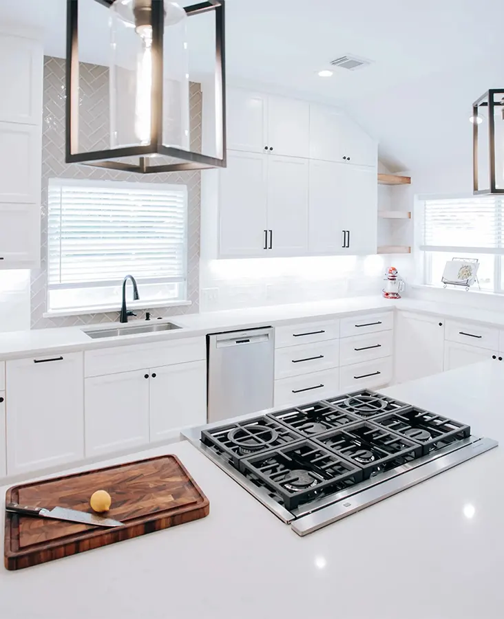 Modern kitchen remodel in The Woodlands with warm cabinetry, quartz countertops and large island