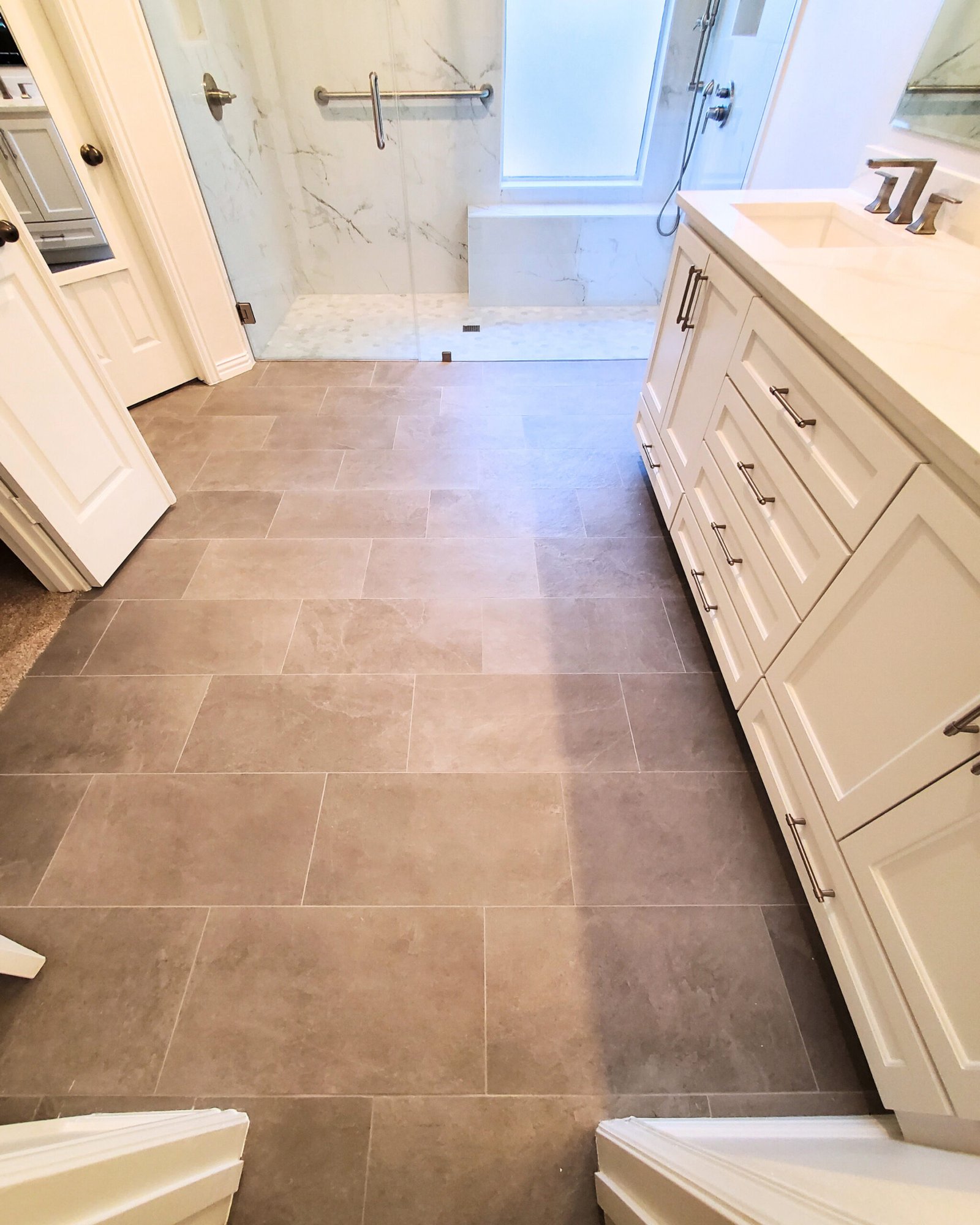 Replace hazardous tubs with spacious walk-in showers and non-slip flooring to eliminate fall risks and enhance mobility.